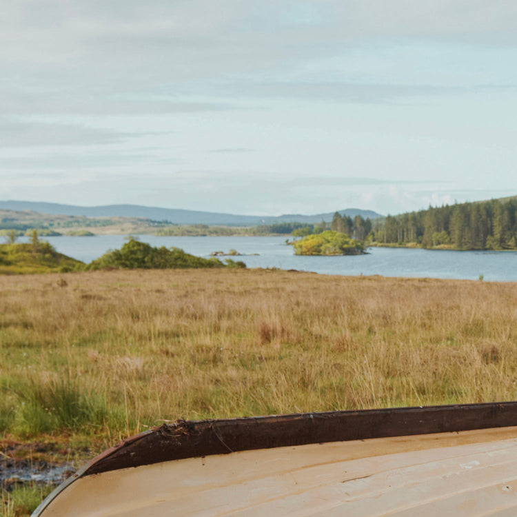 Square Image of the Irish landscape image with blue skies, mountains, forest, and a lake.//© Dubarry of Ireland