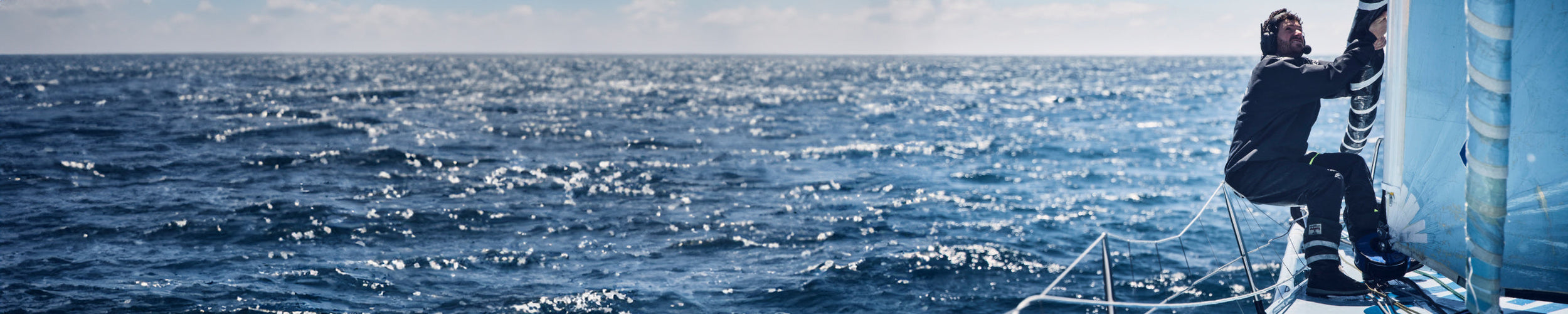 Wide image of a member of team Holcim - PRB working on the boat during the Ocean Race 2023.